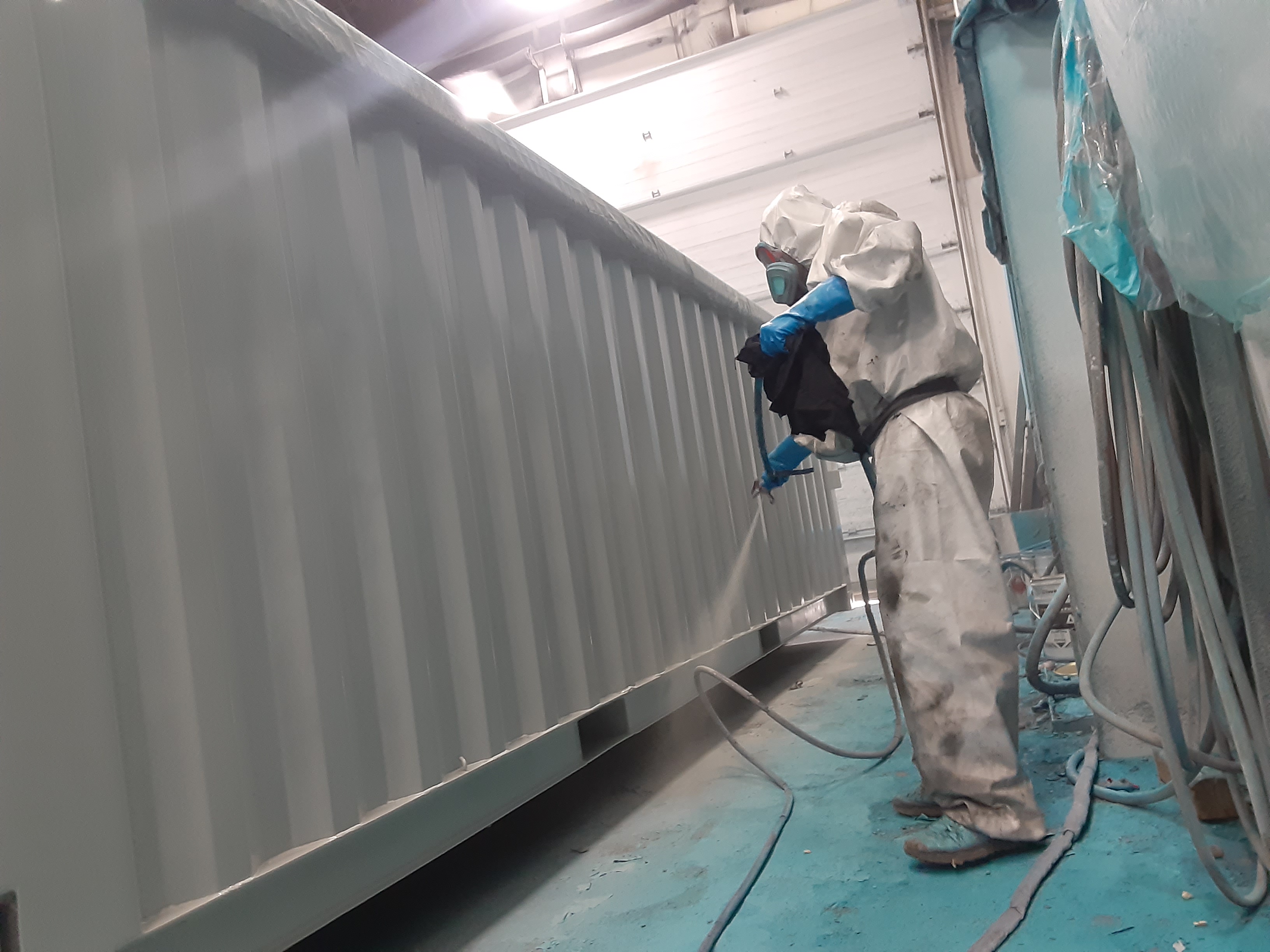 An above ground pool with epoxy primer being applied